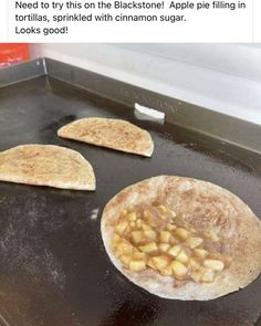 two pita breads sitting on top of an oven pan with apples in them