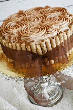 a cake on a glass plate with a bow around it