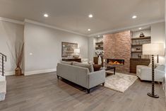 a living room filled with furniture and a fire place in the middle of the room