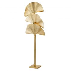 a gold metal sculpture with three leaves on it's sides and a white background