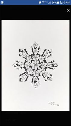 a drawing of a snowflake made with black and white paper