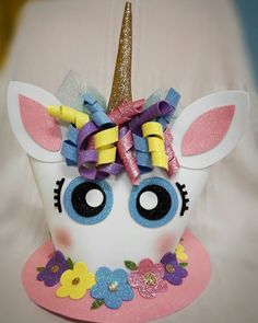 a close up of a stuffed animal with a unicorn's head