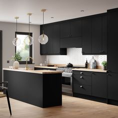 a kitchen with black cabinets and wooden floors