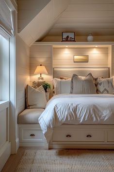 a white bed sitting under a window in a bedroom