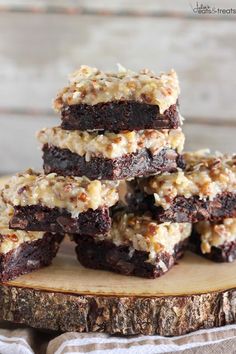 a stack of brownies sitting on top of a wooden cutting board