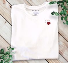 White T-Shirt Personalized Small Heart T-Shirt White Red Heart Women T-shirt Little Heart T-shirt Red Heart T-shirt Cotton Women T-Shirt ROUND COLLAR White T-shirt regular cut and breathable material. Soft and comfortable 100% cotton composition and its well-fitted cut. White Tee Shirt Woman with red heart can be a gift T-shirt for Mother's Day  A nice little set to compose according to your family. Family clothing set to be a Valentine family A nice Valentine's Day gift for women  Personalized Red Heart Graphic T-shirt With Short Sleeves, Red Short Sleeve T-shirt With Heart Graphic, Red Crew Neck T-shirt With Heart Graphic, Red Heart-shaped Graphic Tee, Red Heart-shaped T-shirt With Heart Graphic, Red Crew Neck Top With Heart Graphic, Red Cotton T-shirt With Heart Print, Cotton T-shirt With Heart Print, Red Short Sleeve T-shirt For Valentine's Day