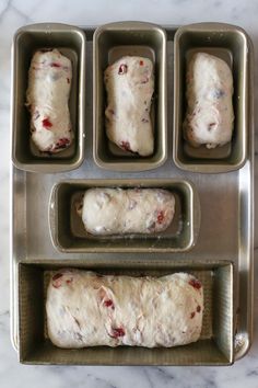 four pans filled with dough sitting on top of a counter