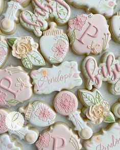 decorated cookies with pink and white frosting are displayed