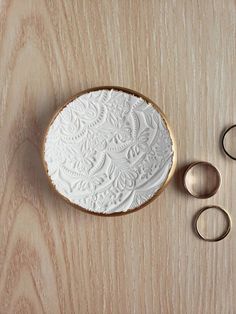 a white plate sitting on top of a wooden table next to two pairs of scissors