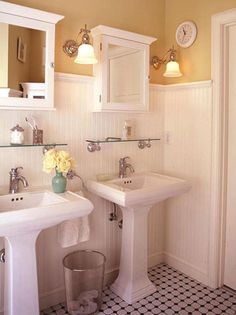 a bathroom with two sinks and a mirror on the wall next to a toilette