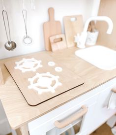 a kitchen counter with cutting boards and utensils on it