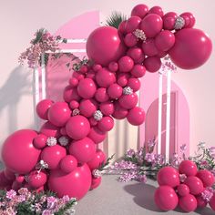 a pink room with balloons and flowers on the floor