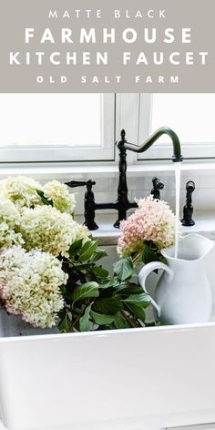 the kitchen sink is filled with flowers and water faucets in front of a window