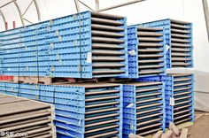 several large blue metal containers stacked on top of each other in a warehouse or building