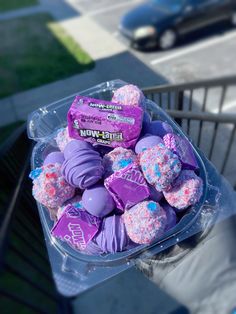 a plastic container filled with purple and pink candy