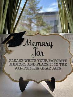 a sign that reads memory jar please write your favorite memory and place it in the jar for the graduate