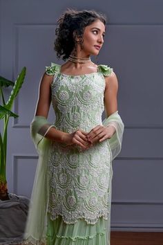 Mint green short frilly sleeves kurta with all over ambrosia embroidery using dori, bugle bead, sequin, pearls highlights. Paired with a gathered frilly tiered sharara and a pearl tasseled tulle dupatta. - Aza Fashions Elegant Green Sharara With Ruffles, Designer Green Dress With Ruffles, Elegant Green Ruffled Sharara, Green Bollywood Sharara With Ruffles, Fitted Green Sharara With Cutdana, Fitted Green Sharara For Reception, Bollywood Style Green Lehenga With Ruffles, Traditional Green Ruffled Sharara, Green Ruffled Sharara For Wedding