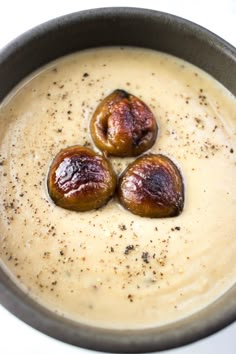 three pieces of food in a bowl on a table