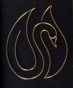 an image of a logo on the side of a black surface with gold foiling