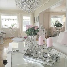 a living room filled with furniture and a chandelier