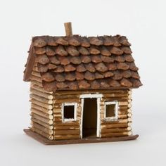 a small log house with a roof made out of logs