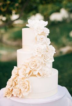 a white wedding cake with flowers on top