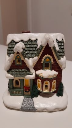 a small toy house with snow on the roof