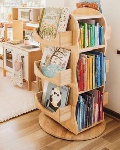 a wooden book shelf filled with books on top of a hard wood floor