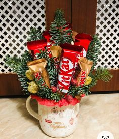 a mug filled with candy and christmas decorations