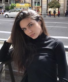 a woman standing in front of a street