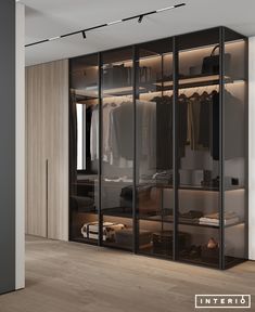 a walk in closet with glass doors and shelves