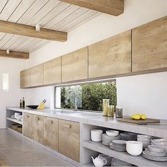 the kitchen is clean and ready to be used for cooking or baking, as well as dishes