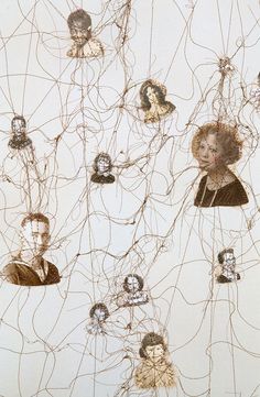 an art work with many different faces and wires on the wall above it, as well as people's heads