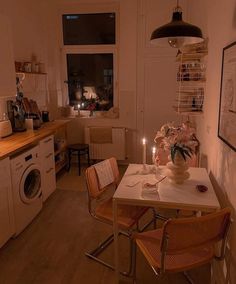 a kitchen with a washing machine and table in it