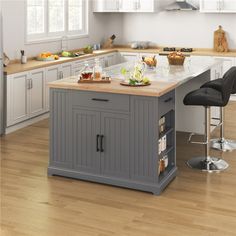 a kitchen island with two stools in front of it and an island on the other side