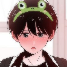 a person with a frog hat on their head