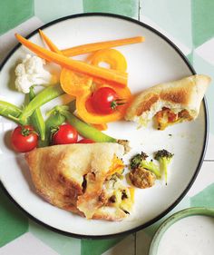 a white plate topped with pizza and veggies