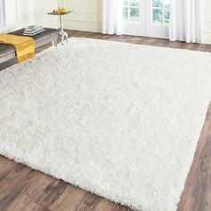 a large white rug in the middle of a living room