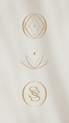 three different logos are shown in gold on white paper, with the letter s below them