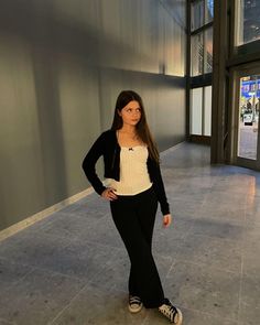 a woman is standing in an empty building