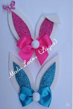 an easter bunny ears with pink and blue glitter bow on it's head, made from paper