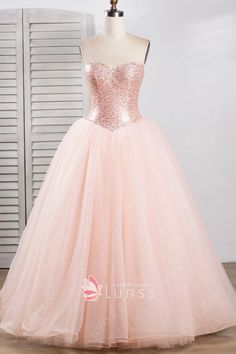 a pink ball gown with sequins on the top and bottom, is displayed