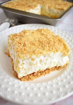 a piece of cake sitting on top of a white plate next to a metal pan