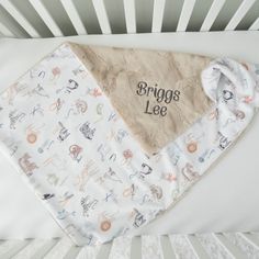 a baby's crib with a bib and blanket on top of it