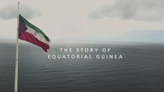 a flag flying in the wind next to the ocean with text that reads, the story of equatoriial guinea