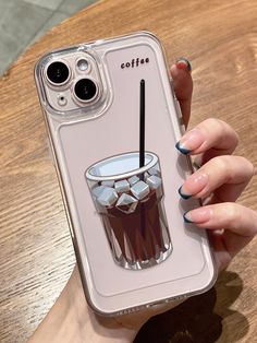 a woman's hand holding an iphone case with a drink on it