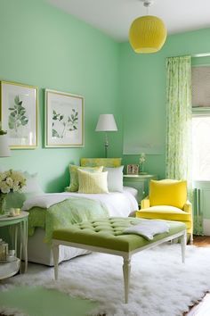 a bedroom with green walls and white furnishing on the floor, yellow accents