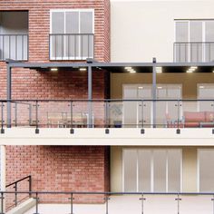 an apartment building with balconies on the second floor