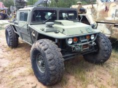 an army vehicle is parked in the dirt