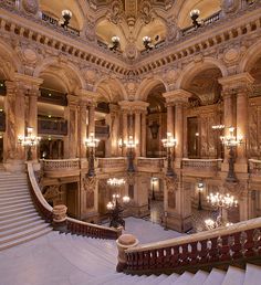 an ornate building with chandeliers and stairs